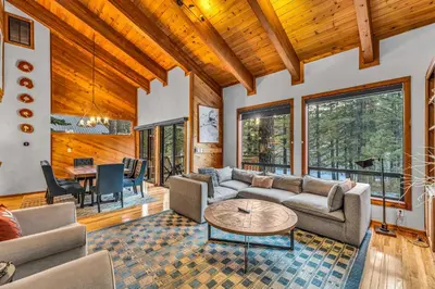 a living room with a couch and a table at Cozy Truckee Vacation Rental with Fireplace & Deck in Truckee
