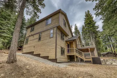 a large wooden house in the woods at Radiant Retreat by Tahoe Getaways - 4 BR in Tahoe Donner with Hot Tub & HOA in Truckee