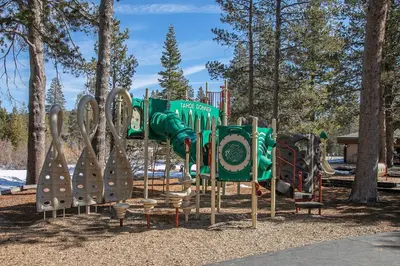 a playground in a park with a bunch of equipment at Radiant Retreat by Tahoe Getaways - 4 BR in Tahoe Donner with Hot Tub & HOA in Truckee