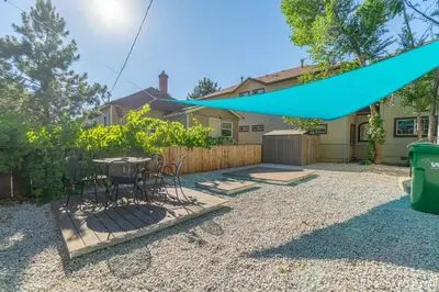 a patio with a table and chairs in a backyard at Charming Family 2BR Midtown Reno - Pets Welcome in Reno