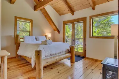 a bedroom with a large bed and windows at Hyphen 3-bedrooms rental, private beach, filtered view in Tahoe City