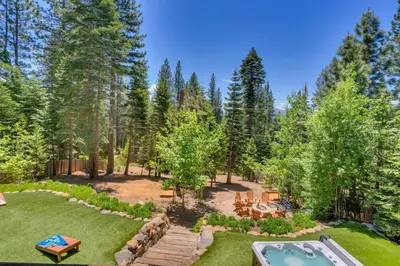 an aerial view of a backyard with a pool and trees at Hyphen 3-bedrooms rental, private beach, filtered view in Tahoe City