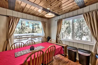 a dining room with a red table and chairs at Bear Haus - Sledding At Cabin - Forest Views - Foosball in South Lake Tahoe