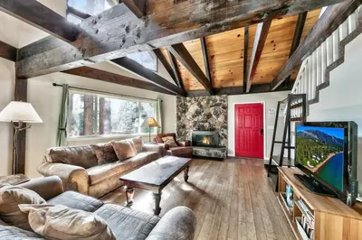 a living room with a couch and a tv at Bear Chalet - Snow Play - 4 Bedrooms - Foosball in South Lake Tahoe