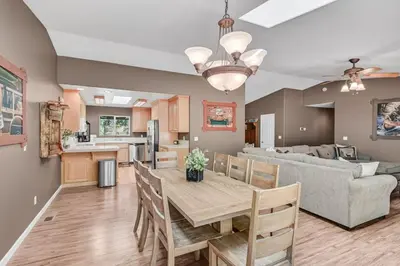 a kitchen and living room with a table and a couch at Great Cabin with AC Firepit Fireplace in Arnold