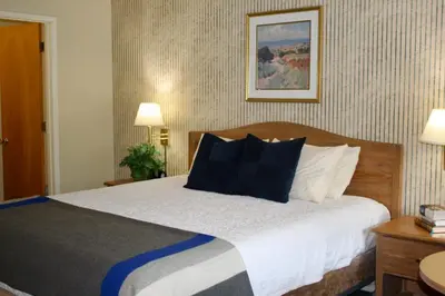 a bedroom with a bed with black and white pillows at Whispering Pines in June Lake