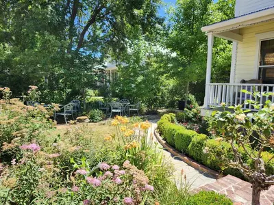 a garden in front of a house with flowers at Brinnwood Bed & Breakfast in Sutter Creek