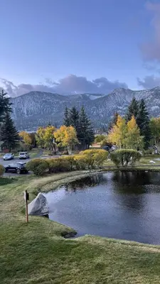 a pond of water with trees and mountains in the background at Scenic Views Hot Tub Ski Shuttle Pet Friendly in Mammoth Lakes
