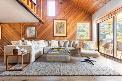 a living room with a couch and a table at Scenic Views Hot Tub Ski Shuttle Pet Friendly in Mammoth Lakes