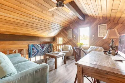 a living room with a couch and a table at Scenic Views Hot Tub Ski Shuttle Pet Friendly in Mammoth Lakes