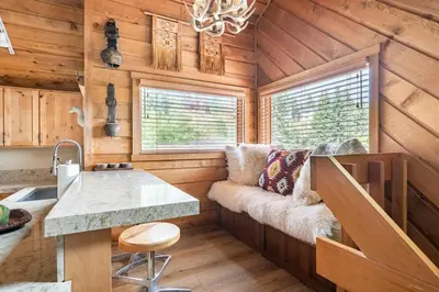 a kitchen and living room of a tiny house at Scenic Views Hot Tub Ski Shuttle Pet Friendly in Mammoth Lakes