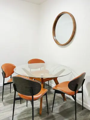 a table with chairs and a mirror on a wall at Orchard Parks in Tracy