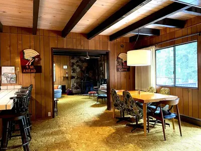 a dining room with a table and chairs at Groovy Cabin in the Woods in Pollock Pines