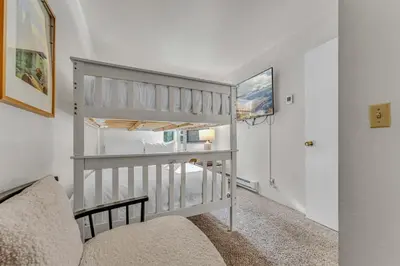 a room with a loft bed and a staircase at Cozy Carnelian Bay Escape with Deck and Foosball in Carnelian Bay