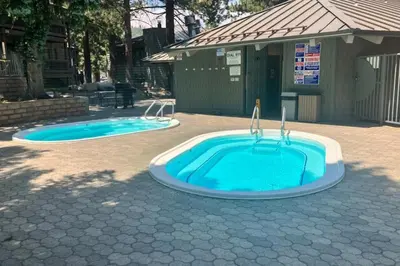 two swimming pools are sitting in a yard at Sierra Park Villas 40 H in Mammoth Lakes