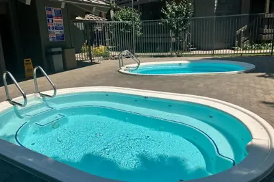 two jacuzzi hot tubs in a yard at Sierra Park Villas 40 H in Mammoth Lakes