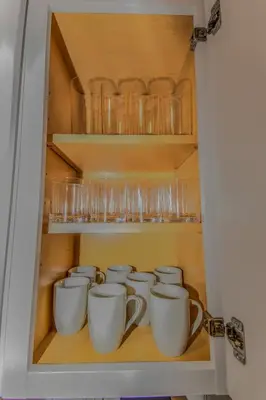 a cupboard filled with lots of cups and glasses at Reno Retreat 3 King Beds by Casinos and University in Reno