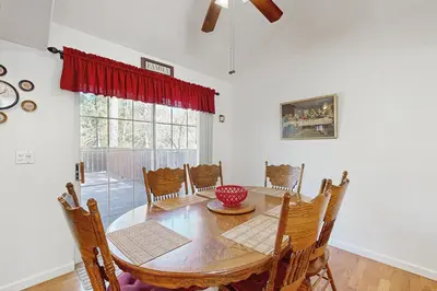 a dining room with a wooden table and chairs at Casa Cardoso in Groveland