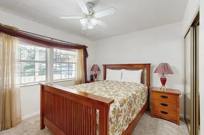 a bedroom with a bed and a ceiling fan at Casa Cardoso in Groveland