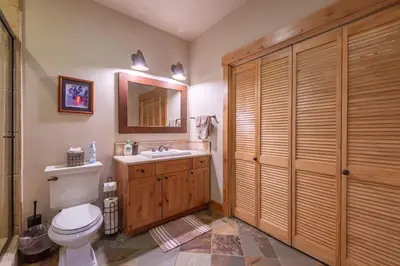 a bathroom with a toilet and a sink and a mirror at Deluxe Truckee Townhome 3BDR Dog Friendly Great Location in Truckee