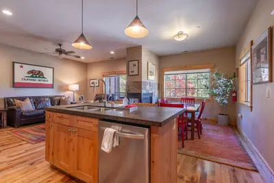 a kitchen and living room with a sink and a table at Deluxe Truckee Townhome 3BDR Dog Friendly Great Location in Truckee