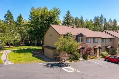 a house with a car parked in a parking lot at Cozy Condo for 8 Hot-Tub HOA Amenities Walk to Beach Close to Slopes in Tahoe City