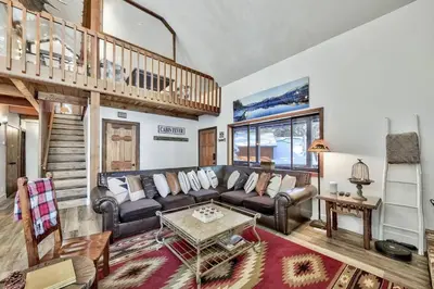a living room with a couch and a table at Cozy Cabin&HotTub Mins to N StarSki Sleeps 12 in Tahoe Vista