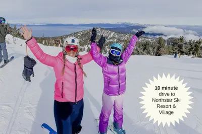 two people standing in the snow with their arms up at Cozy Cabin&HotTub Mins to N StarSki Sleeps 12 in Tahoe Vista