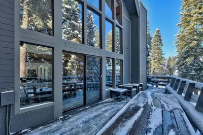 a building with benches and tables in the snow at Cozy Cabin&HotTub Mins to N StarSki Sleeps 12 in Tahoe Vista