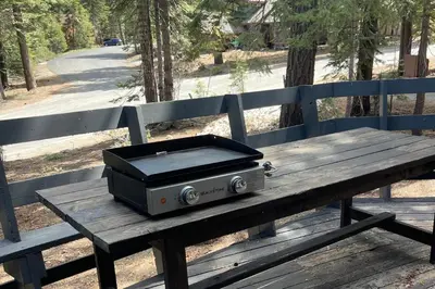 a toaster sitting on a wooden picnic table at Cozy Cabin&HotTub Mins to N StarSki Sleeps 12 in Tahoe Vista