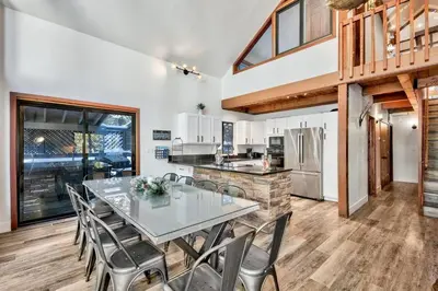 a dining room with a table and chairs in a kitchen at Cozy Cabin&HotTub Mins to N StarSki Sleeps 12 in Tahoe Vista