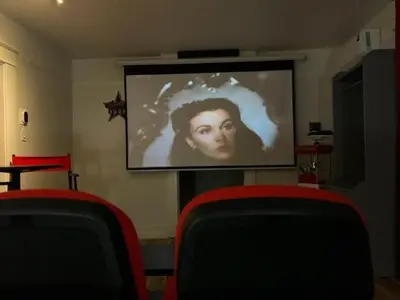 a projection screen with a picture of a woman on it at Reno MidTown Movie House in Reno