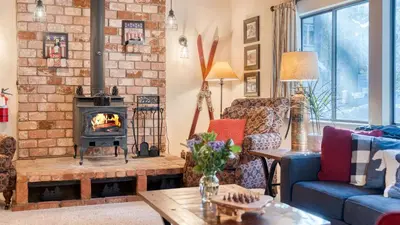 a living room with a brick wall and a fireplace at Mountain Cabin w Fireplace Balcony Easy Ski Access Bear Americana in Truckee