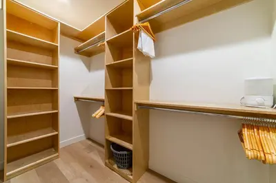 a walk in closet with wooden shelves at Spectacular New 4BR Townhome: Garage, Jacuzzi, BBQ in Mammoth Lakes