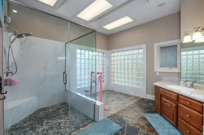 a bathroom with a shower and a sink at Yosemite Gateway Sleeps 18 - Coarsegold Villa near Bass Lake in Coarsegold