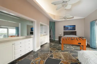 a bedroom with a bed and a table in it at Yosemite Gateway Sleeps 18 - Coarsegold Villa near Bass Lake in Coarsegold