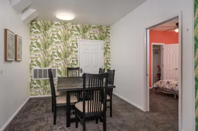 a dining room with a table and chairs and a bedroom at Yosemite Gateway Sleeps 18 - Coarsegold Villa near Bass Lake in Coarsegold