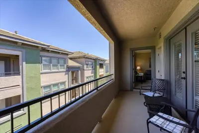 a balcony with two chairs and a window at New Luxurious 1BR Apartment Heated Pool Spa & Sauna in Reno