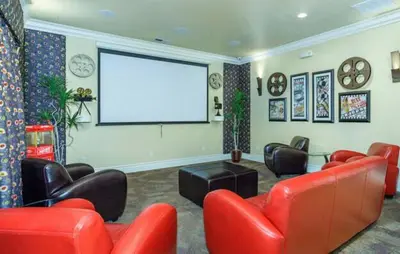 a living room with red furniture and a white screen at New Luxurious 1BR Apartment Heated Pool Spa & Sauna in Reno