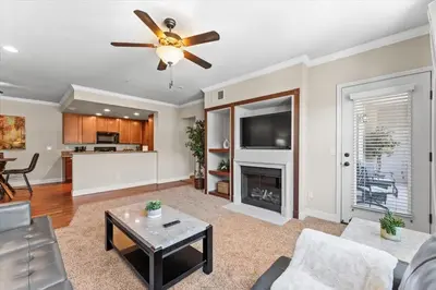 a living room with a ceiling fan and a fireplace at New Luxurious 1BR Apartment Heated Pool Spa & Sauna in Reno