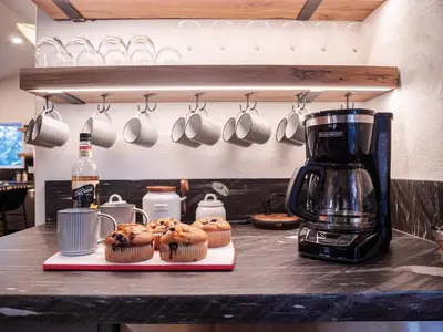 a counter with a coffee maker and cupcakes on a counter at Mountain Retreat near Skiing, HotTub, PetFriendly in Tahoe City