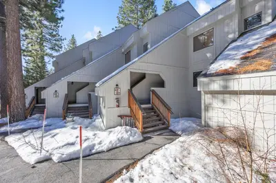 a white building with snow on the ground at Alpine Retreat in the Heart of Incline Village condo in Incline Village