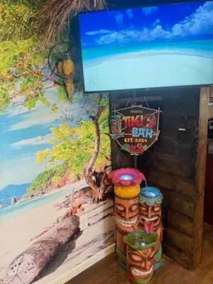 a wall with a painting of a bar with two skulls at Beach House Staycation in Sparks