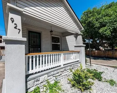 a house with a white fence and a porch at MidTown Art Deco in Reno
