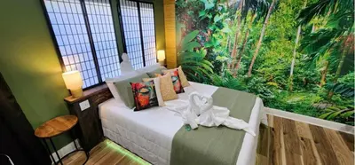 a bedroom with a bed in a room with a mural at MidTown Zen Den in Reno