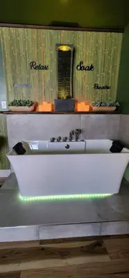 a white bath tub in a bathroom with a mirror at MidTown Zen Den in Reno