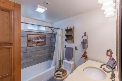 a bathroom with a sink and a toilet and a tub at Luxurious Yosemite Pines Lodge, Pool, Spa, Ponies, Views in Mariposa