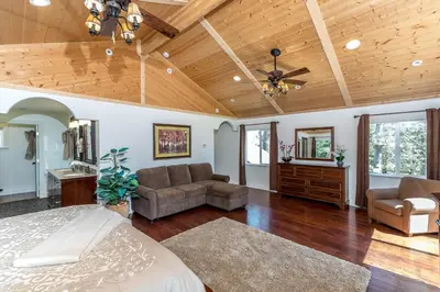 a large room with a bed and a ceiling fan at Luxurious Yosemite Pines Lodge, Pool, Spa, Ponies, Views in Mariposa