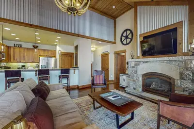 a living room with a couch and a fireplace at Northstar Escape + Northstar Getaway in Truckee
