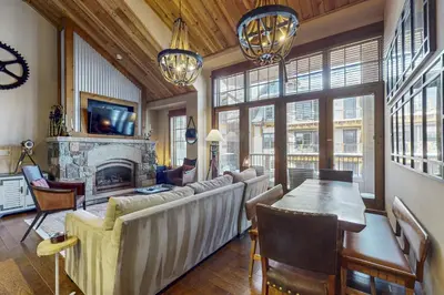 a living room with a couch and a fireplace at Northstar Escape + Northstar Getaway in Truckee